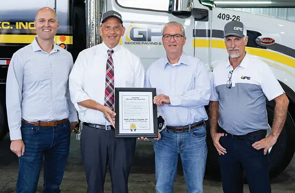 City of Toledo Mayor Wade Kapszukiewicz (second left) presents a proclamation to (from left) Geddis Paving & Excavating’s Vice President Benjamin Geddis, Owner Robert Geddis Jr. and President Steve Oliver for the company’s 80 years of service.